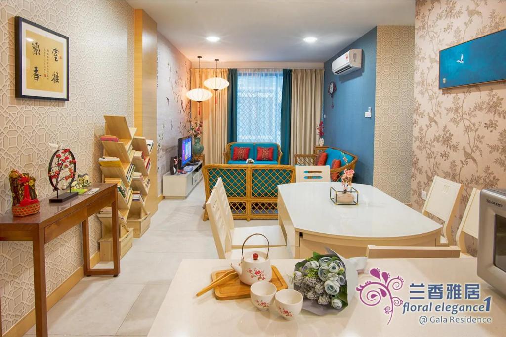 a living room with a table and a dining room at Floral Elegance1 @ Galacity in Kuching