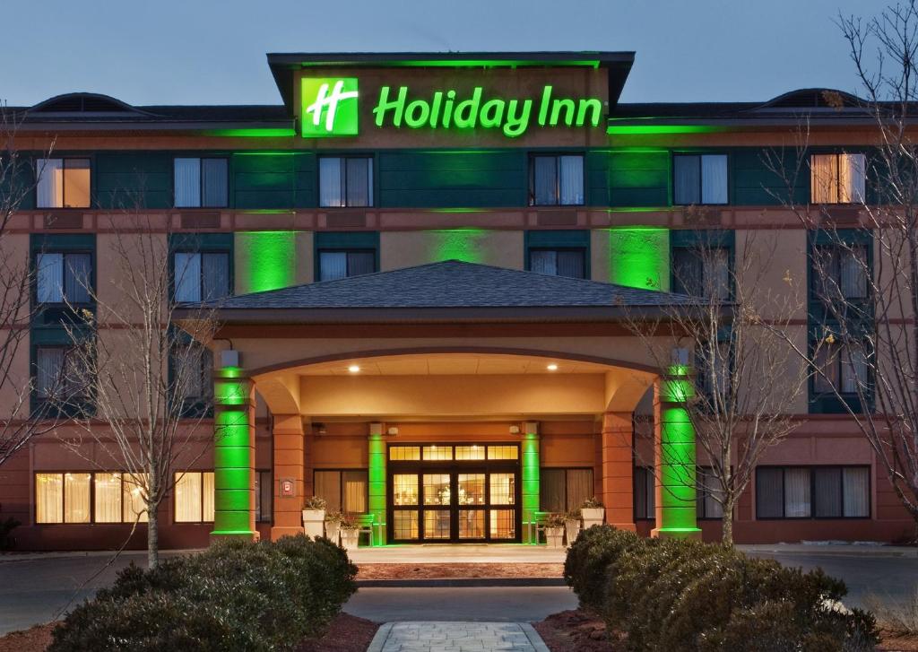 a hospital building with a green sign on it at Holiday Inn Manchester Airport, an IHG Hotel in Manchester