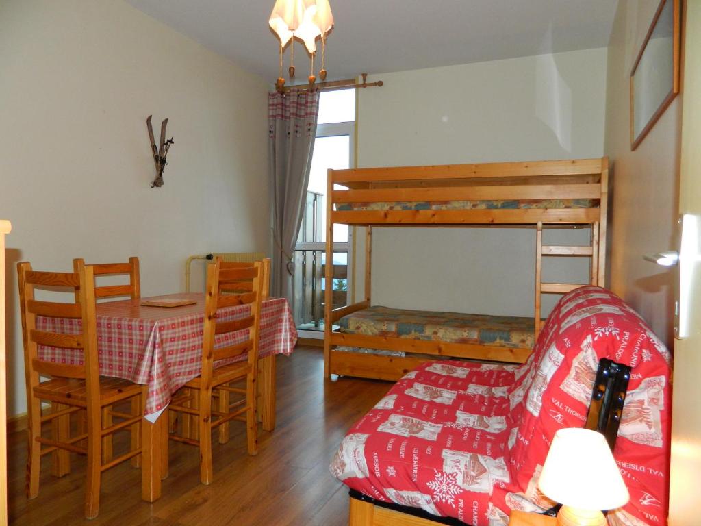 a living room with a table and a bunk bed at clos des gentianes in Allevard