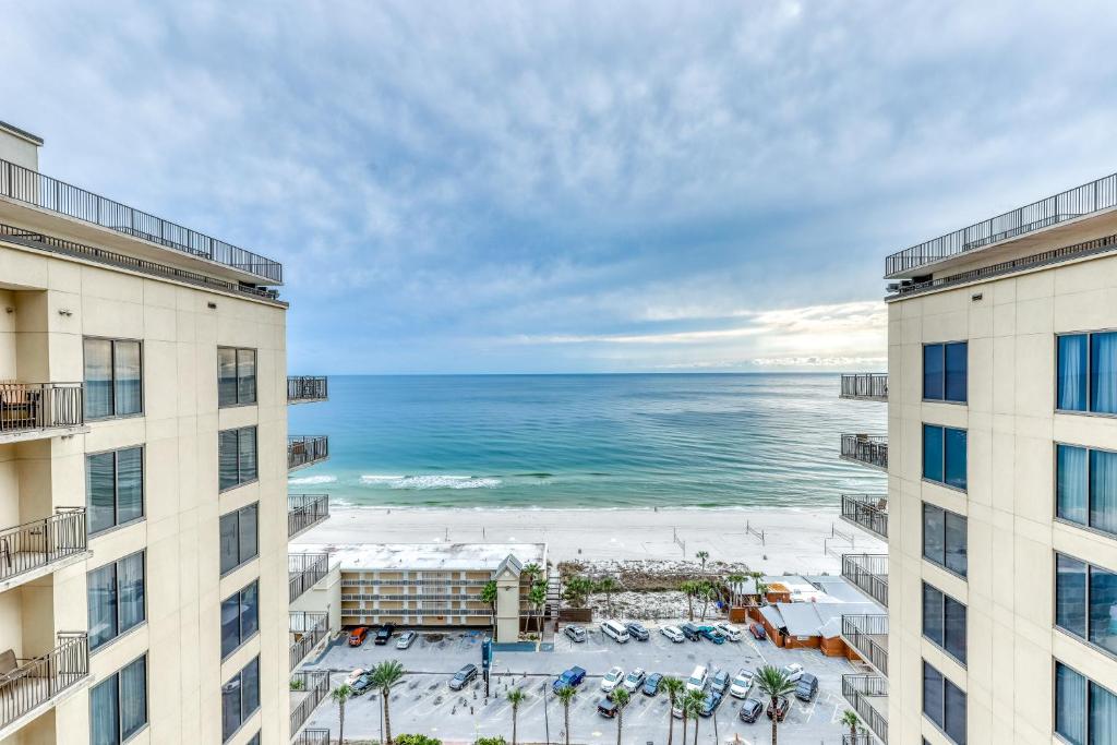 a view of the beach from between two buildings at Origin at Seahaven in Panama City Beach