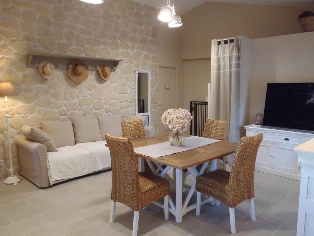 a living room with a table and a couch at Provence Luberon Bonnieux Location Gite Chez Basile in Bonnieux