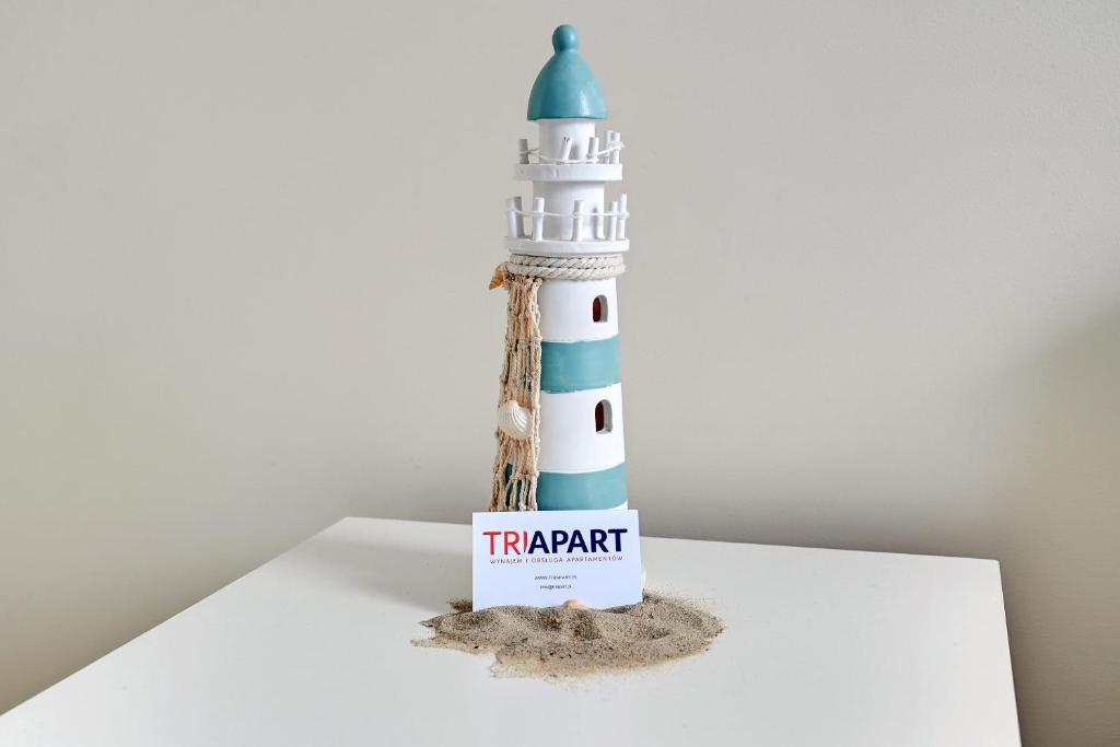 a lighthouse toy sitting on top of a table at TriApart Amber Jantar III in Jantar