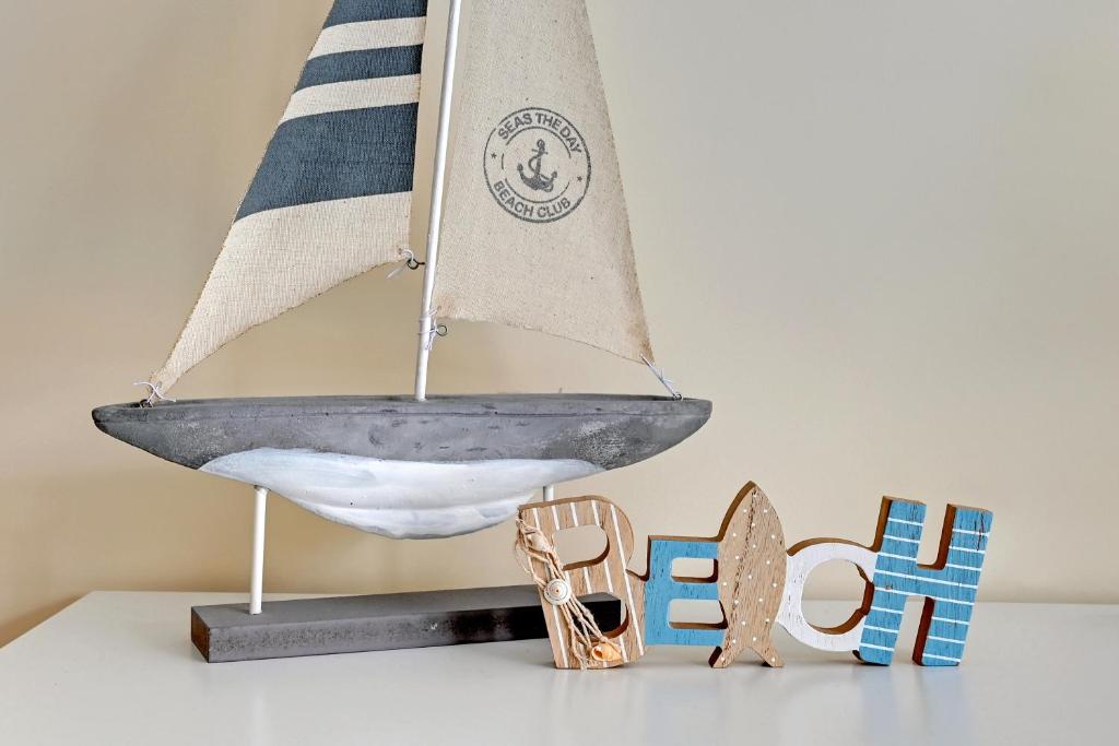 a sail boat on a shelf with a pair of shoes at TriApart Amber Jantar in Jantar