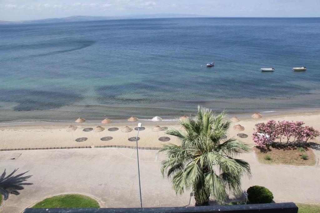 an aerial view of a beach with umbrellas and the ocean at VİLLA FUAT in Erdek