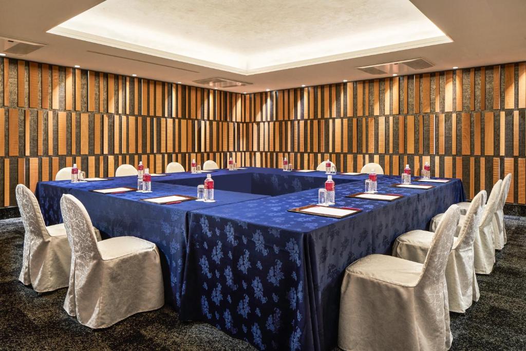 a meeting room with a blue table and chairs at ANA Crowne Plaza Hotel Kyoto by IHG in Kyoto