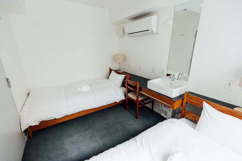 Postel nebo postele na pokoji v ubytování KéFU stay & lounge