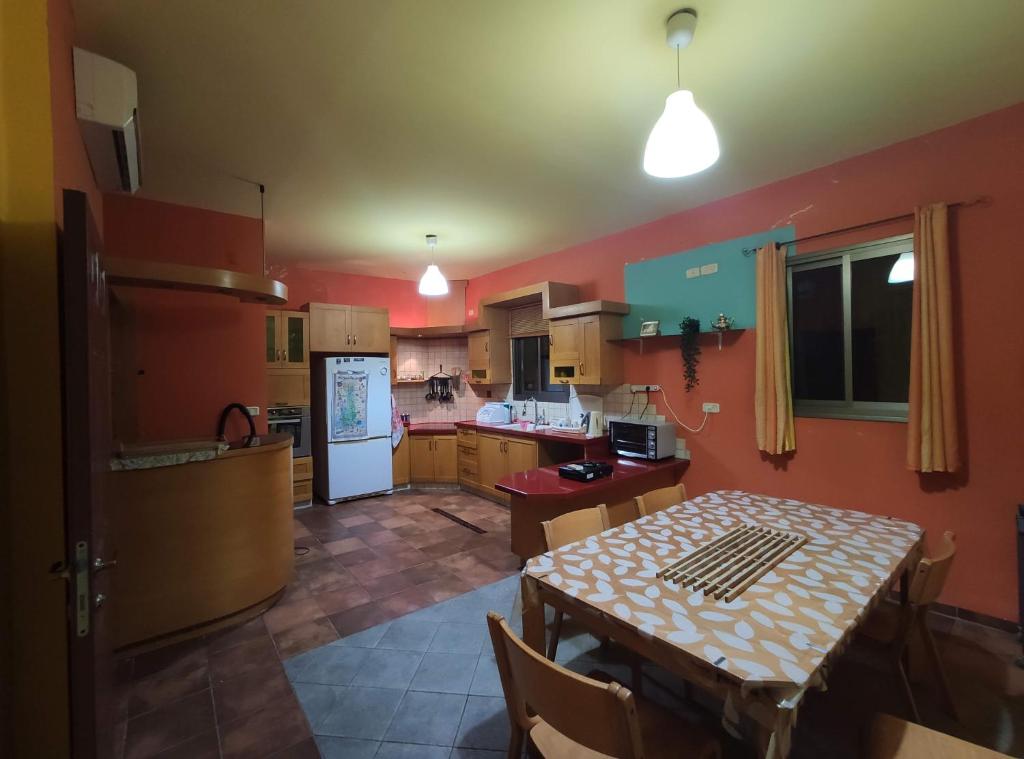 a kitchen with a table and a dining room at Nest House Haifa in Haifa