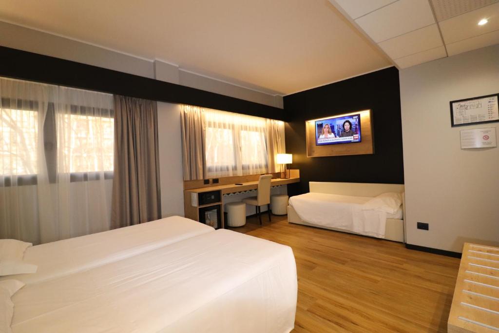 Postel nebo postele na pokoji v ubytování Hotel Domenichino