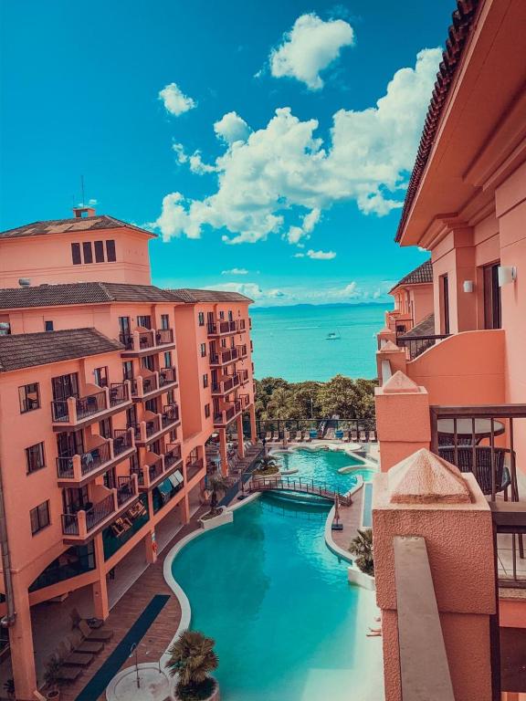 a view of a pool from a balcony of a building at Jurerê Beach Village - Flat na Praia in Florianópolis