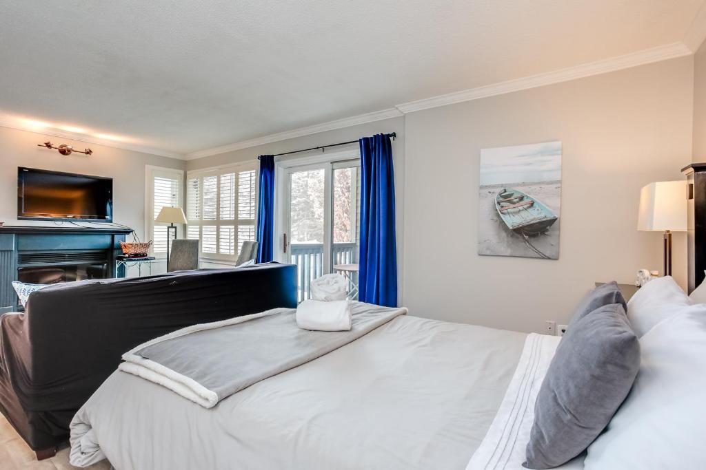 a bedroom with a large bed and a window at Mountainside Resort Condo at Blue in Blue Mountains