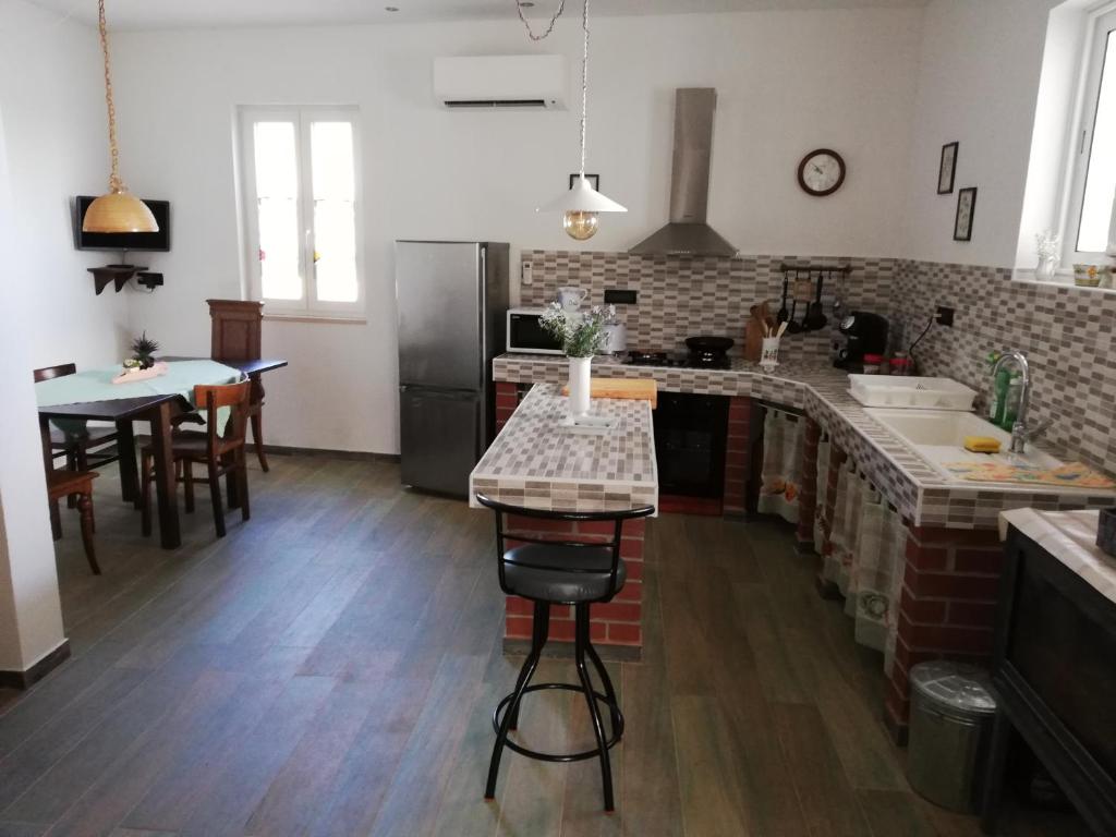 a kitchen with a counter and a table in it at Villa Frane 101 in Beli