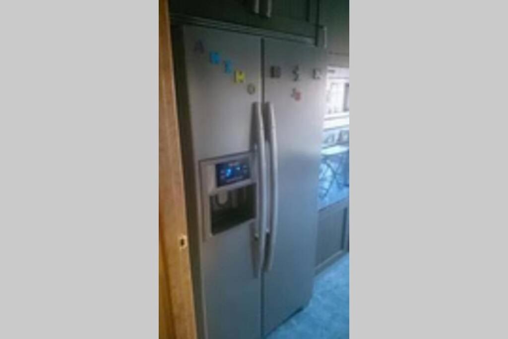 a white refrigerator freezer sitting in a kitchen at Piso en Los corrales de buelna (Cantabría) in Los Corrales de Buelna