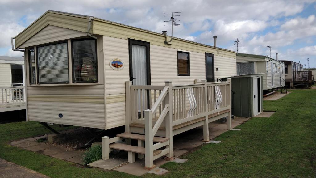 a mobile home with a porch and a deck at 6 Berth Promanade Ingoldmells Arizona in Ingoldmells