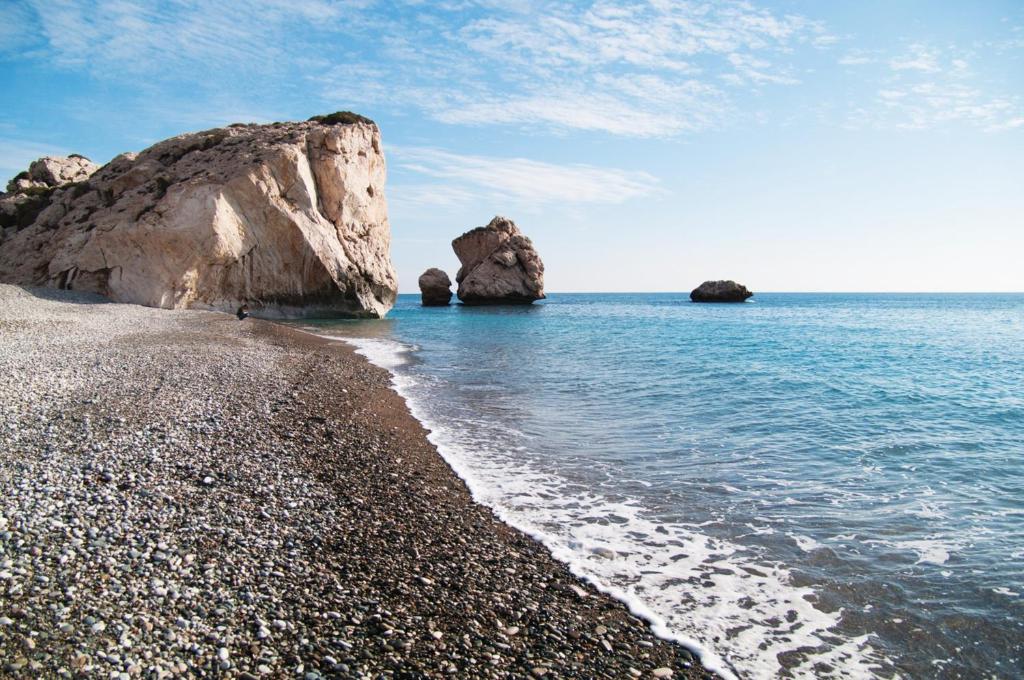 a rocky beach with two large rocks in the water at Crowne Plaza Limassol by IHG in Limassol