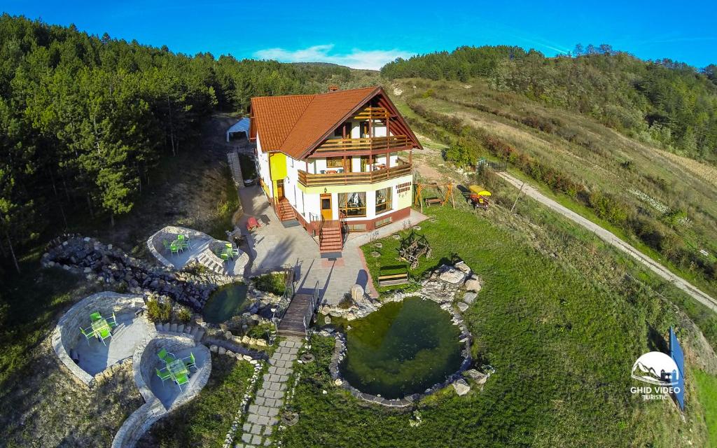 an aerial view of a house on a hill at Pensiunea Armonia in Nădăşelu