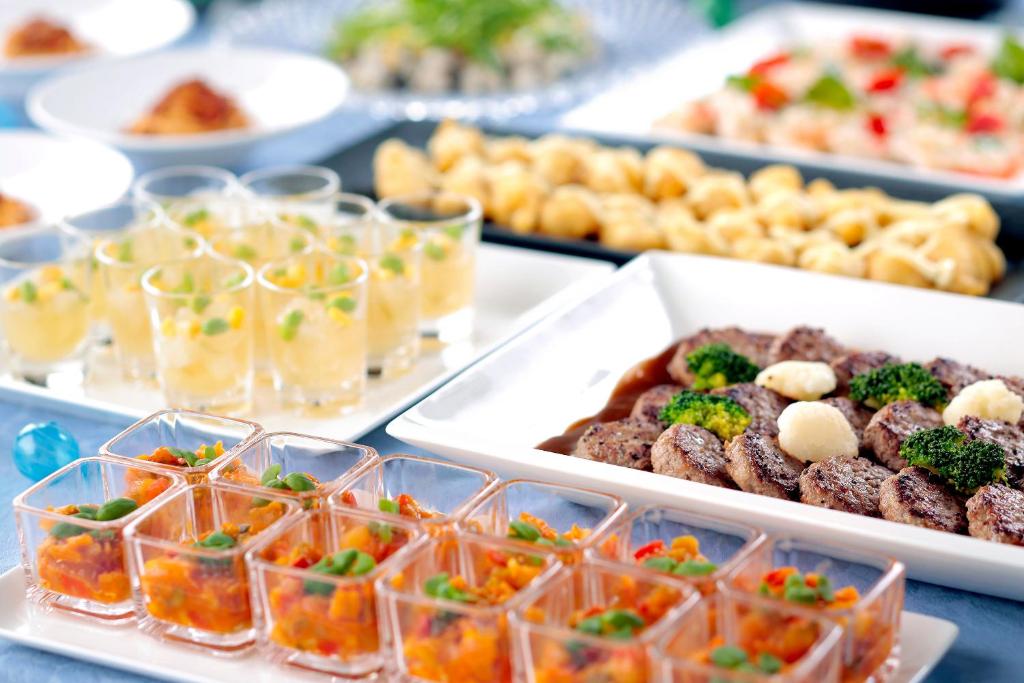 a table with several trays of food on it at ANA Crowne Plaza Hotel Kyoto by IHG in Kyoto