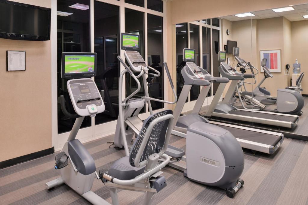 a gym with treadmills and elliptical machines at Holiday Inn Kansas City Airport, an IHG Hotel in Kansas City