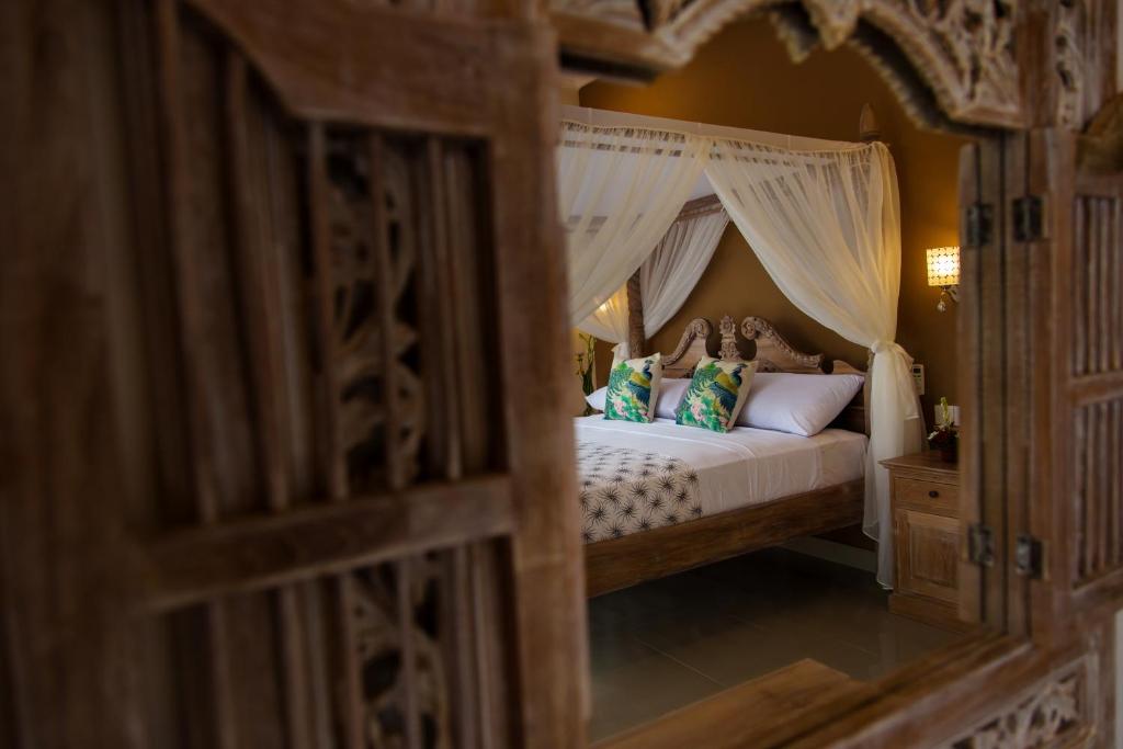 Postel nebo postele na pokoji v ubytování Warji House 1 Ubud Centre