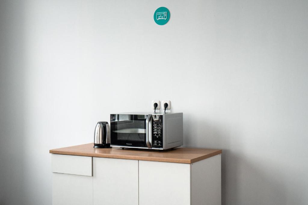a microwave oven sitting on top of a counter at Bobopod Kota Tua, Jakarta in Jakarta
