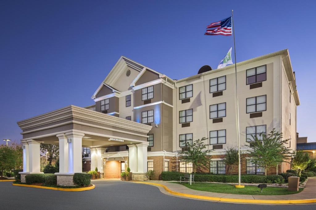 an image of a hotel with an american flag on top at Holiday Inn Express Hotel & Suites Byron, an IHG Hotel in Byron