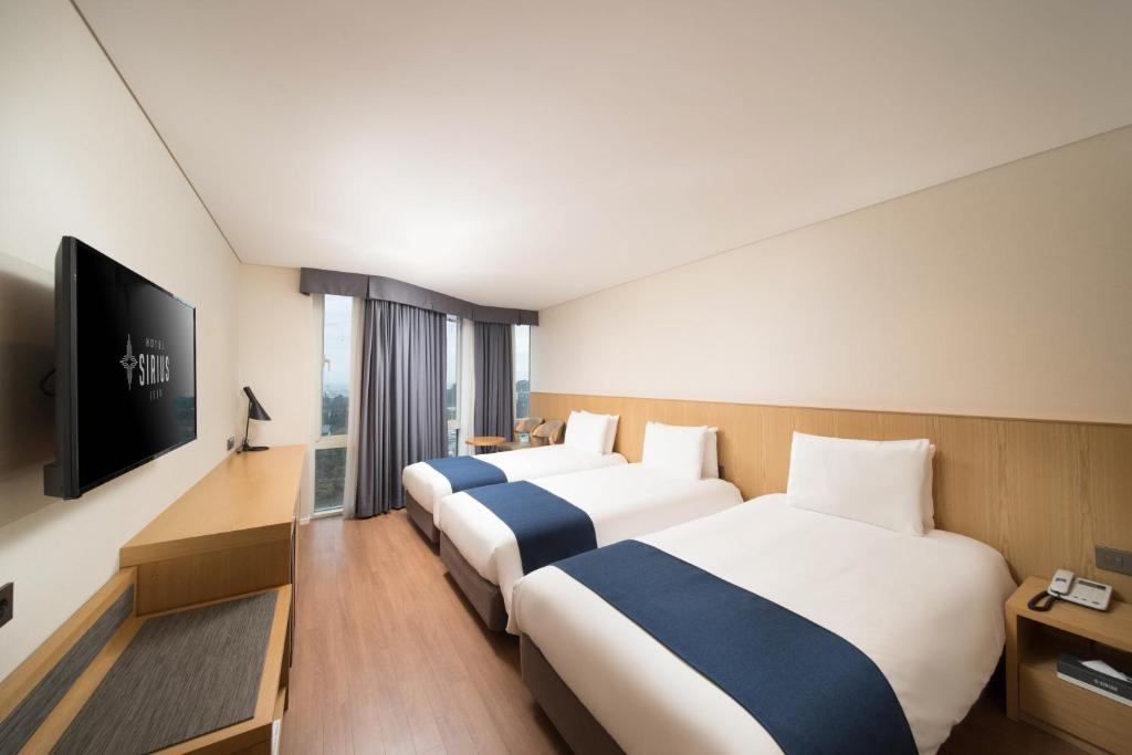 Postel nebo postele na pokoji v ubytování Hotel Sirius