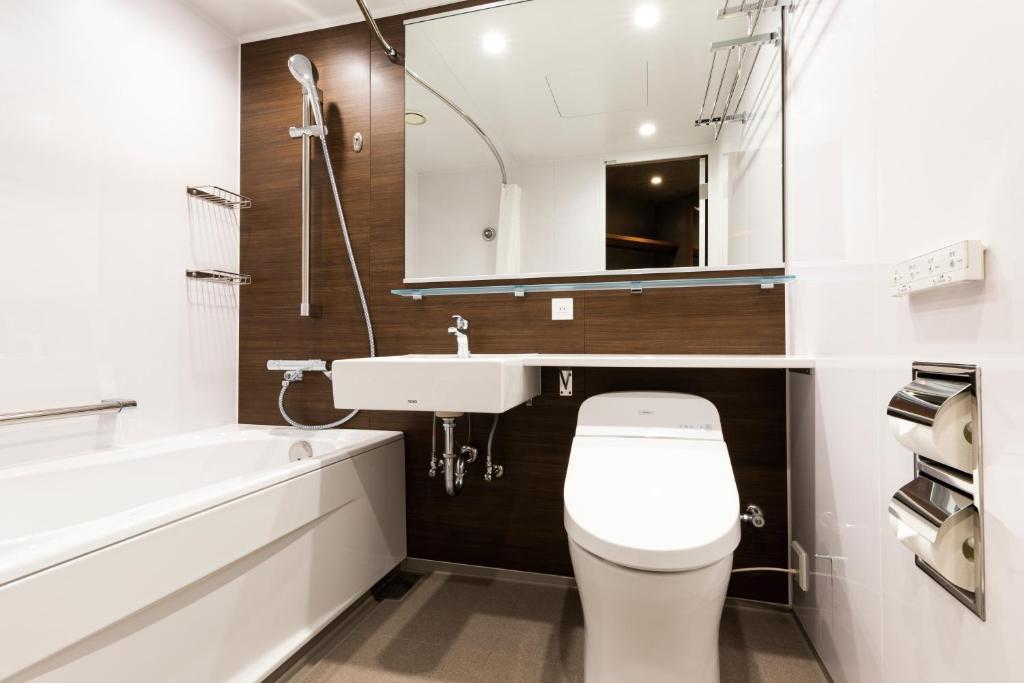 a bathroom with a toilet and a sink and a bath tub at Hotel JAL City Haneda Tokyo in Tokyo
