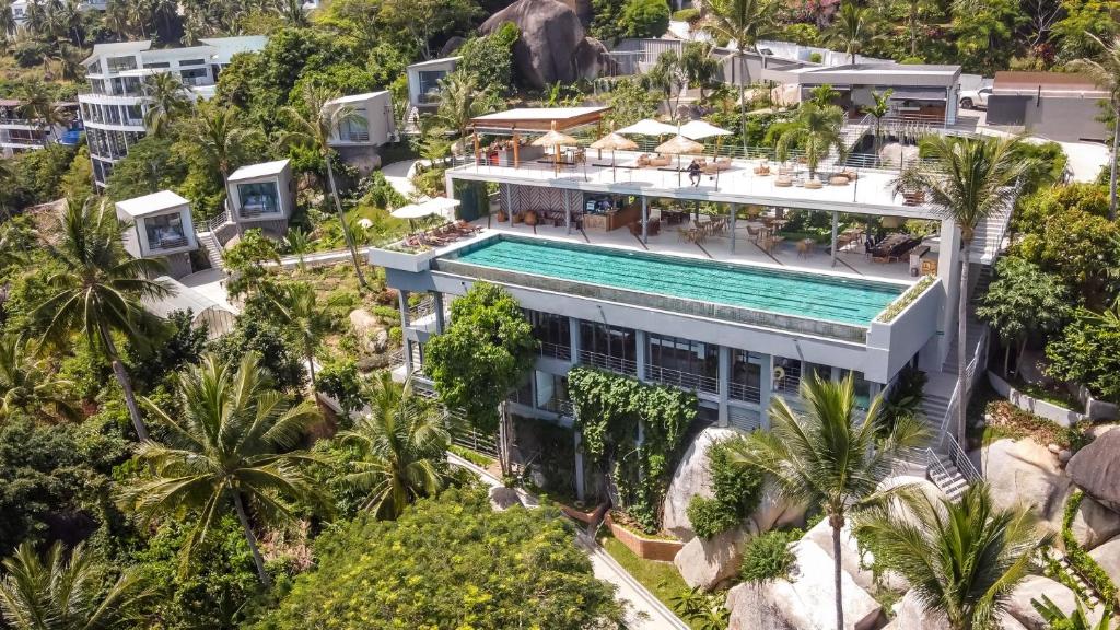 an aerial view of a building with a swimming pool at Kapuhala Koh Samui- Vegan Boutique Hotel in Chaweng Noi Beach