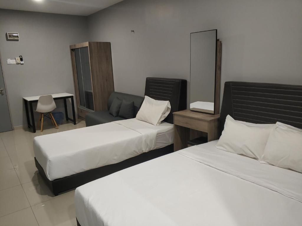 Postel nebo postele na pokoji v ubytování Reno Hotel Ipoh