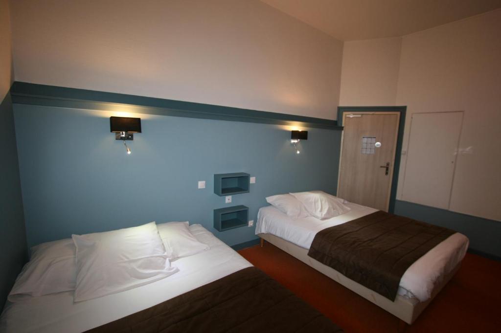 Postel nebo postele na pokoji v ubytování Hôtel Le Picardy