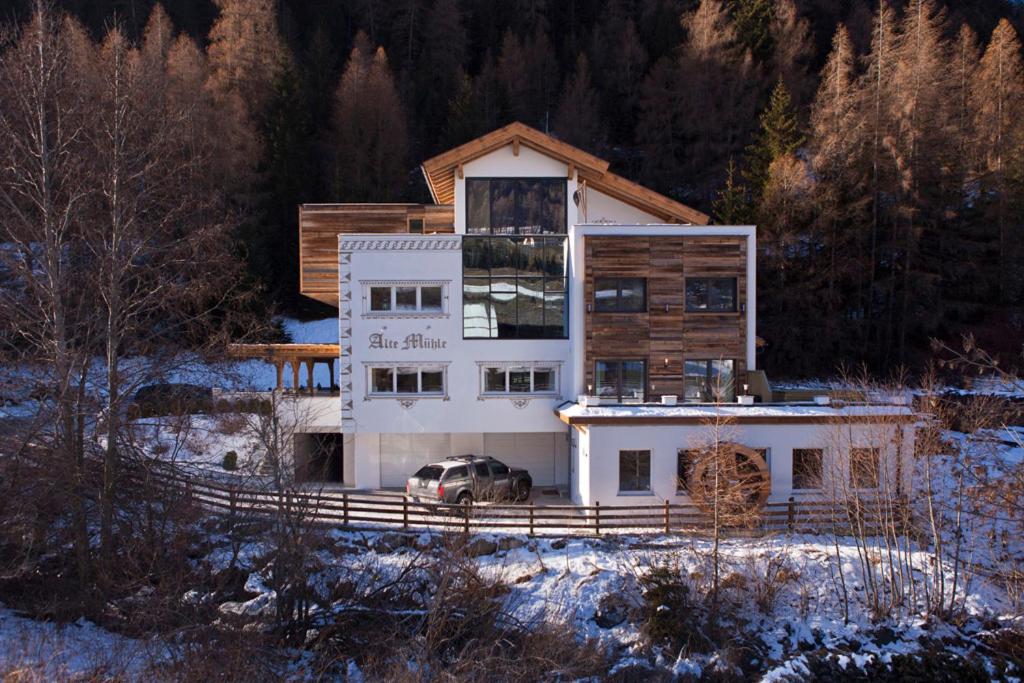 a house with a car parked in front of it at Alte Mühle in Nauders