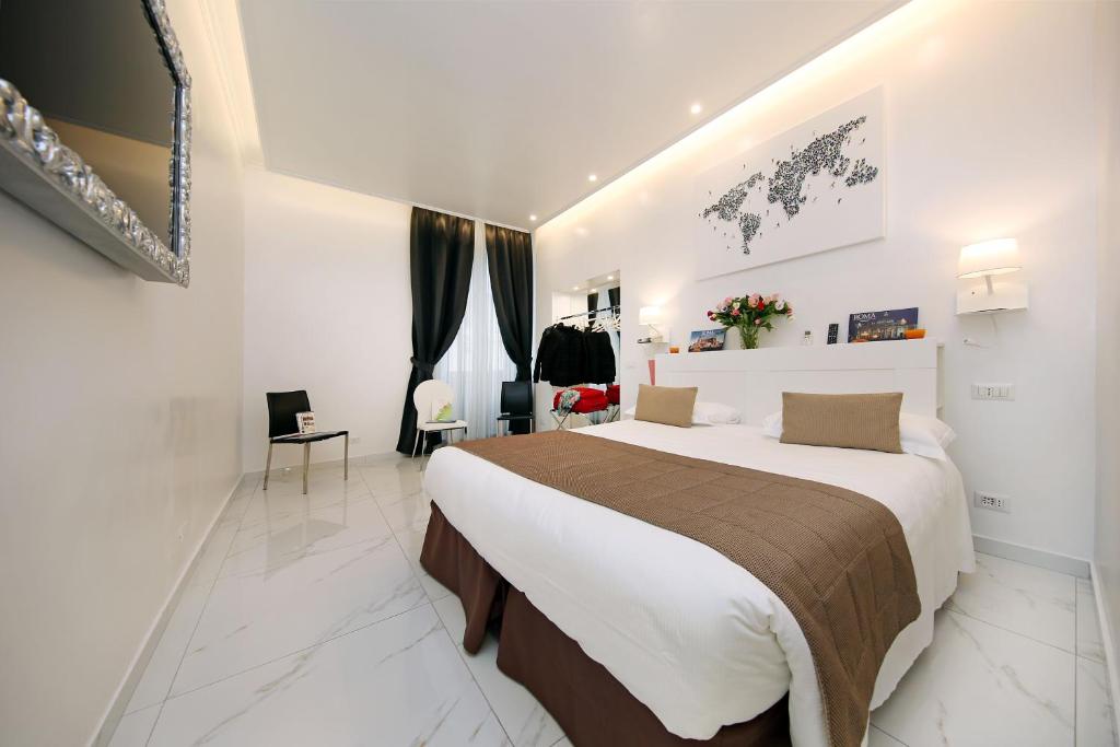 a bedroom with a large bed in a room at La Maisonnette Tritone Trevi Apartment Rome in Rome