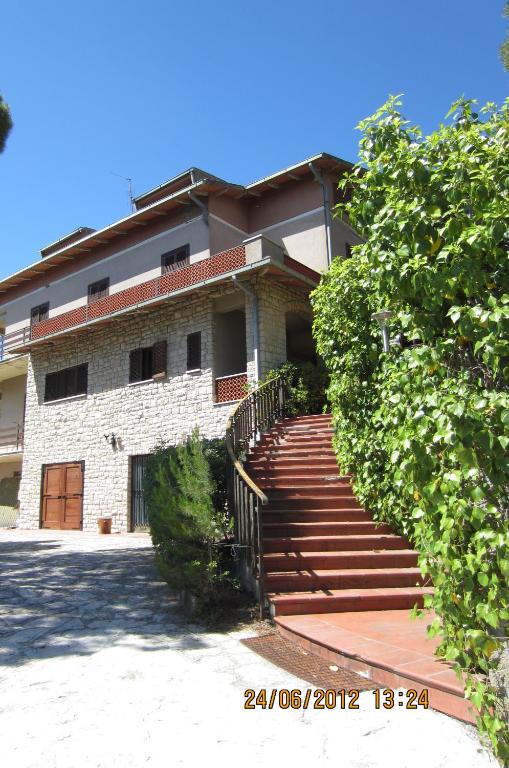 a house with a staircase in front of it at villamuna in Ferentillo