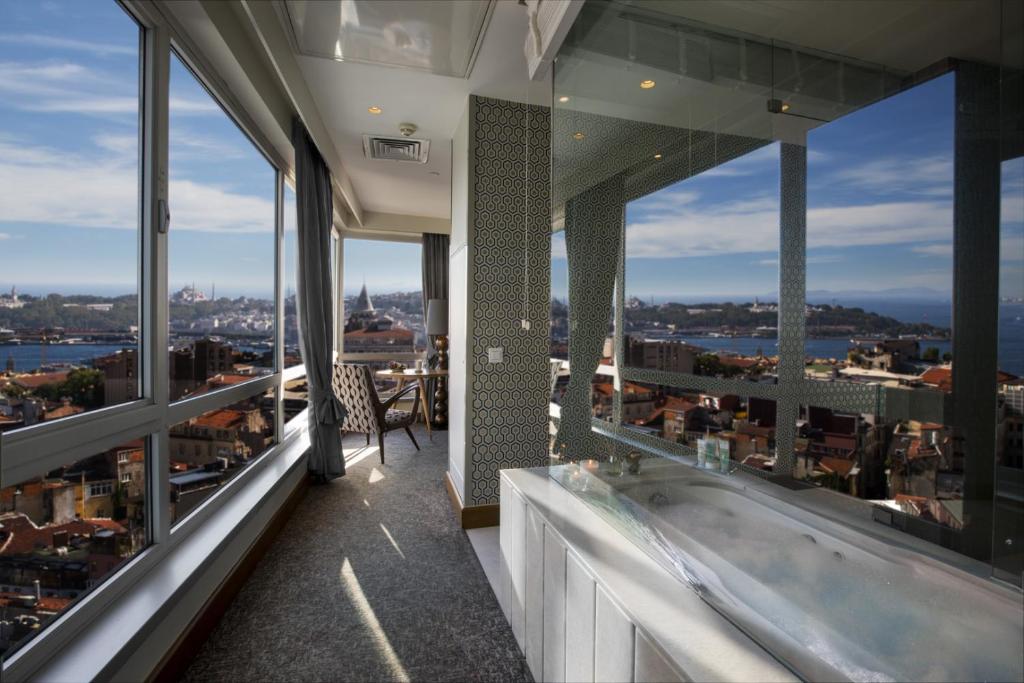 a balcony with a bath tub on top of a building at The Marmara Pera in Istanbul