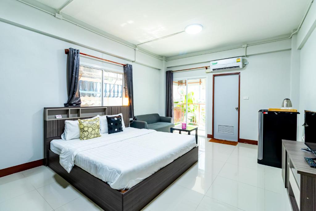 a bedroom with a large bed and a window at Tree Place in Bangkok