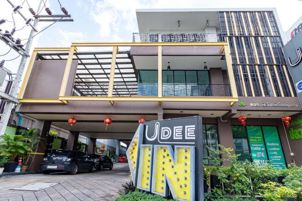 a uber sign in front of a building at Udee Living Place in Hat Yai