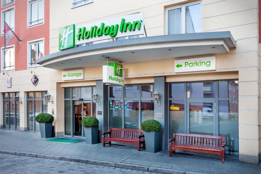 a store with two benches in front of it at Holiday Inn Nürnberg City Centre, an IHG Hotel in Nuremberg