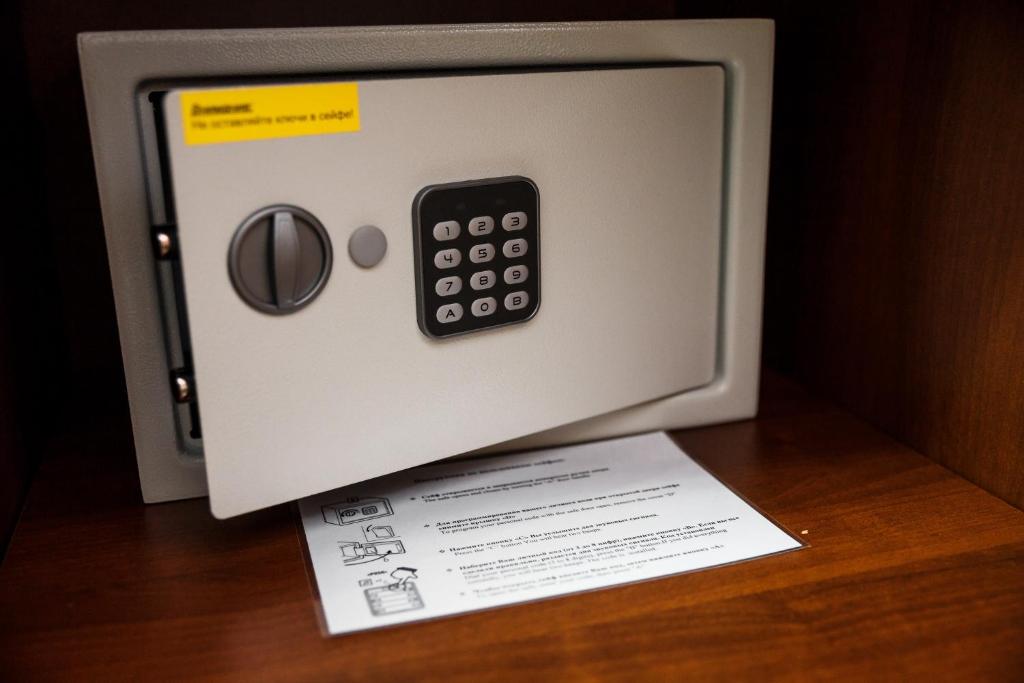 a microwave with a remote control on top of a piece of paper at AZIMUT Hotel Kemerovo in Kemerovo