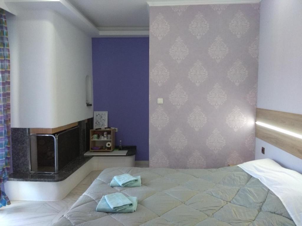A bed or beds in a room at Villa Agnanti Apts and Suites