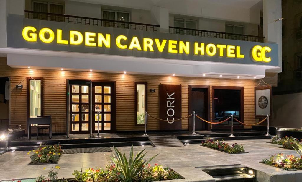 a hotel with a yellow sign on the front of it at Golden Carven Hotel in Cairo