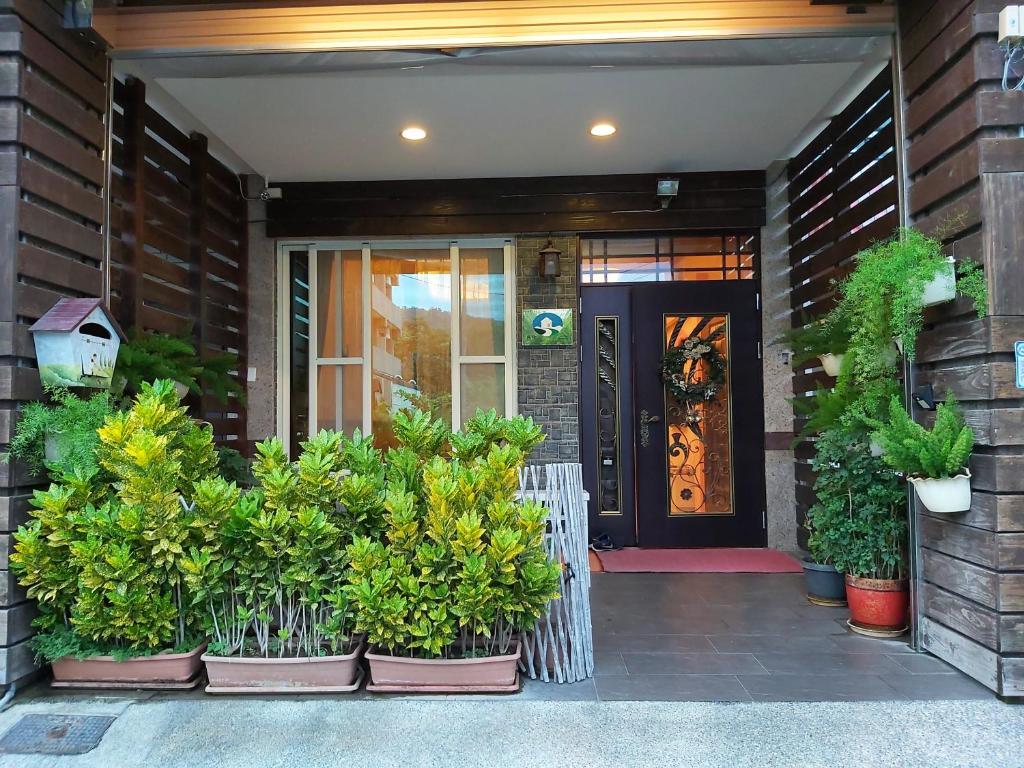 a front door of a house with potted plants at Happy Heart B&B in Taitung City