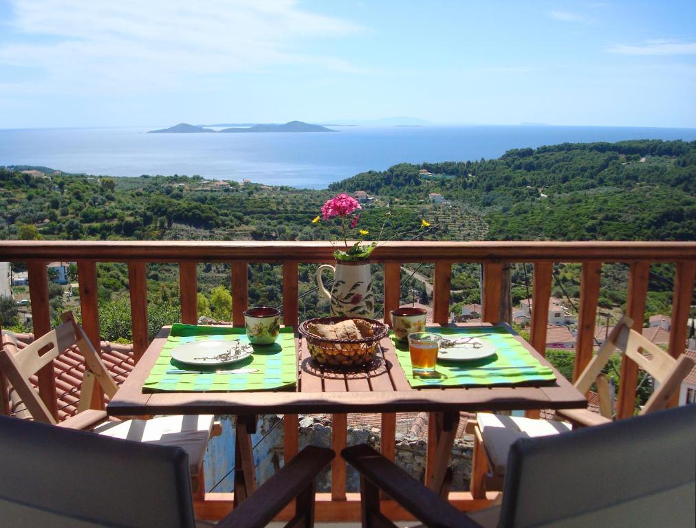 a table on a balcony with a view of the ocean at Asteri Apartments in Alonnisos