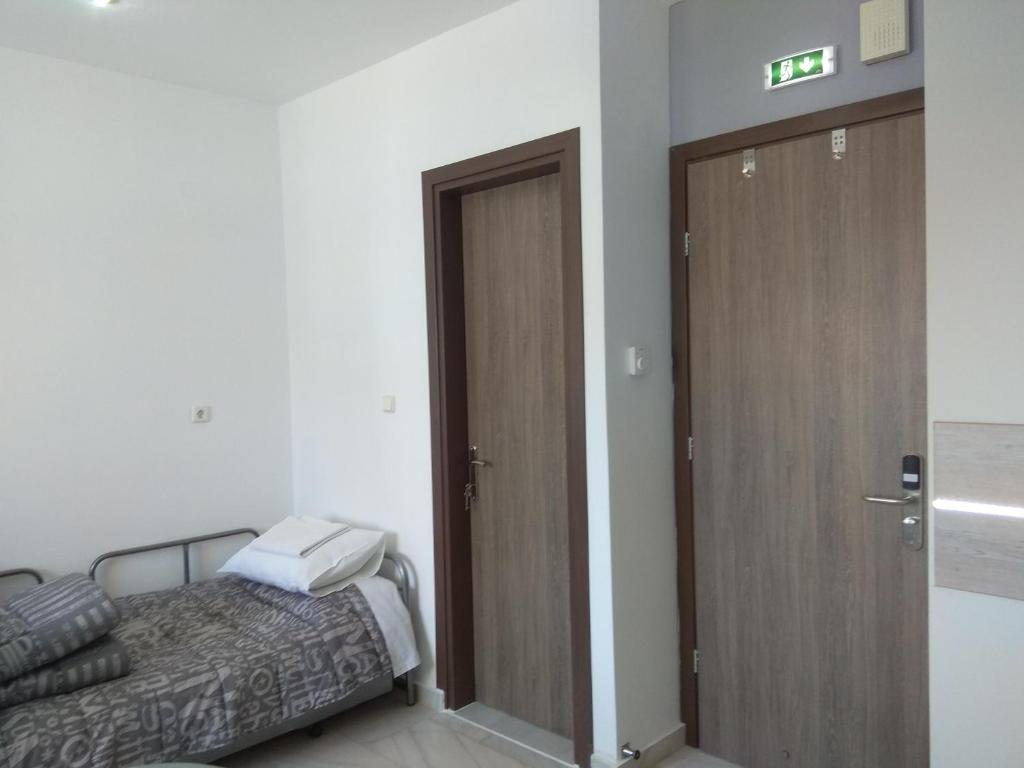 A bed or beds in a room at Villa Agnanti Apts and Suites