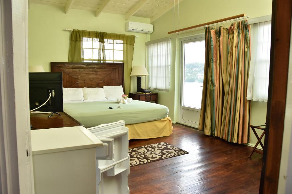 a bedroom with a bed and a large window at Aanola Villas 6b Tranquil Privy Boudoir in Charlotte