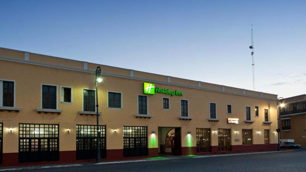 a building with a neon sign on the side of it at Holiday Inn Veracruz-Centro Historico, an IHG Hotel in Veracruz