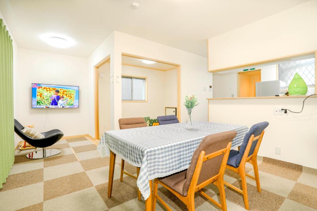 a kitchen and dining room with a table and chairs at Zenith's House in Osaka