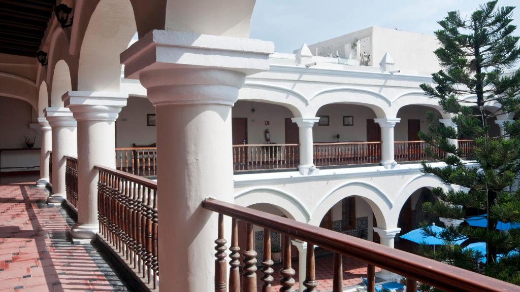 a building with white columns and a balcony at Holiday Inn Express Veracruz Centro Historico by IHG in Veracruz