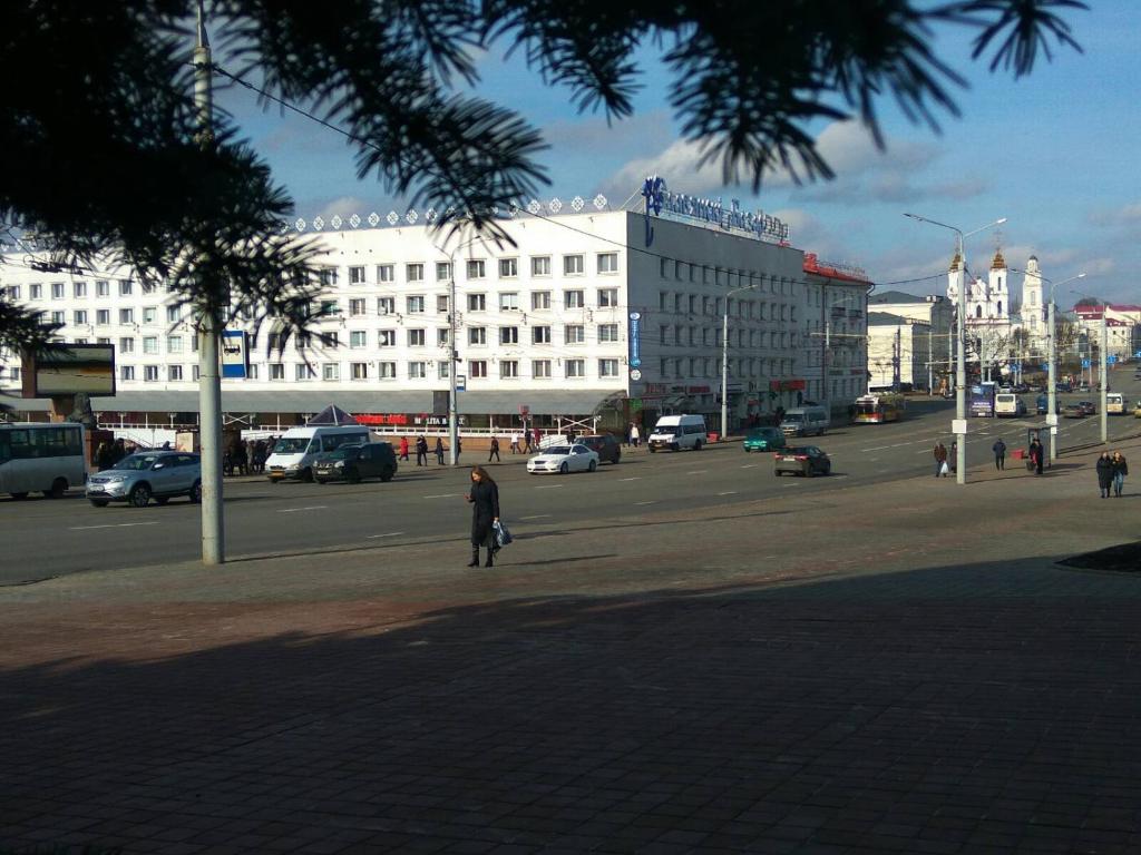 a person standing on a street in a city at Апартаменты в самом центре Витебска in Vitebsk