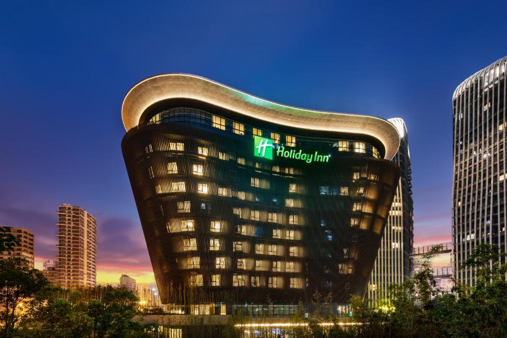 a building with a sign on the side of it at Holiday Inn - Nanjing South Station, an IHG Hotel in Nanjing