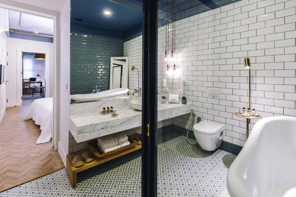 a bathroom with a toilet, sink and bathtub at The Soul Istanbul Hotel in Istanbul