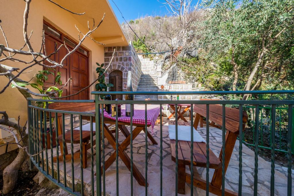 a balcony of a house with chairs and stairs at Skadar lake Apartments Pajovic in Virpazar